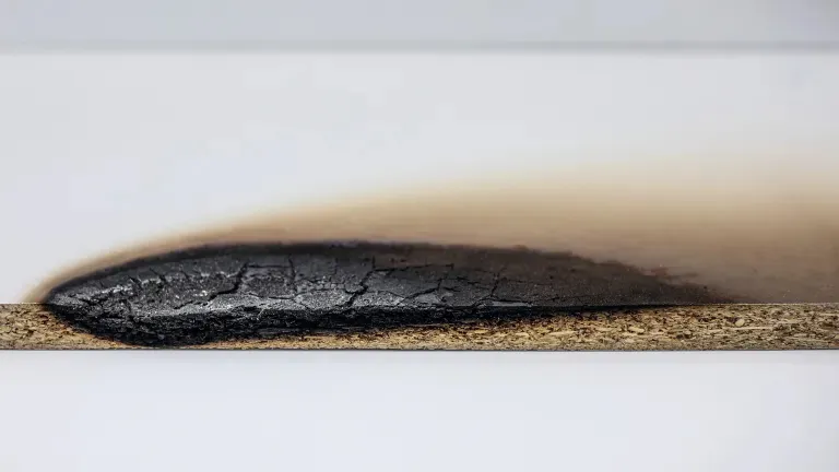 Standard decorative board after 30 minutes of open-flame testing